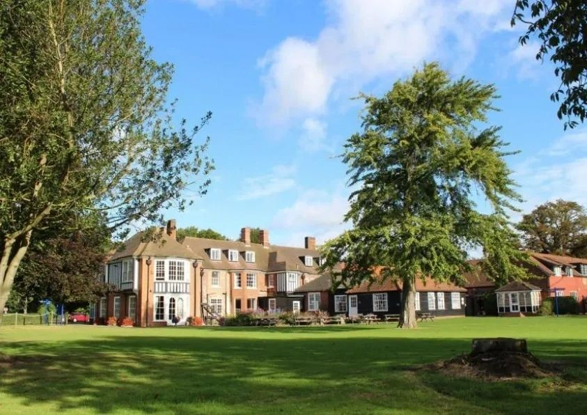 The Old Hall seen across the lawn on a sunny day